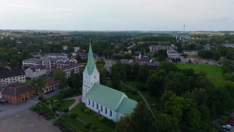 aerial panorama of dobele town center and evangelical lutheran church at summer scenic drone view in golden hour light over dobeles historic center on a warm summer evening peaceful latvian town