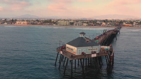 drone orbit at tin fish seafood restaurant at imperial beach pier in sand diego, california, usa