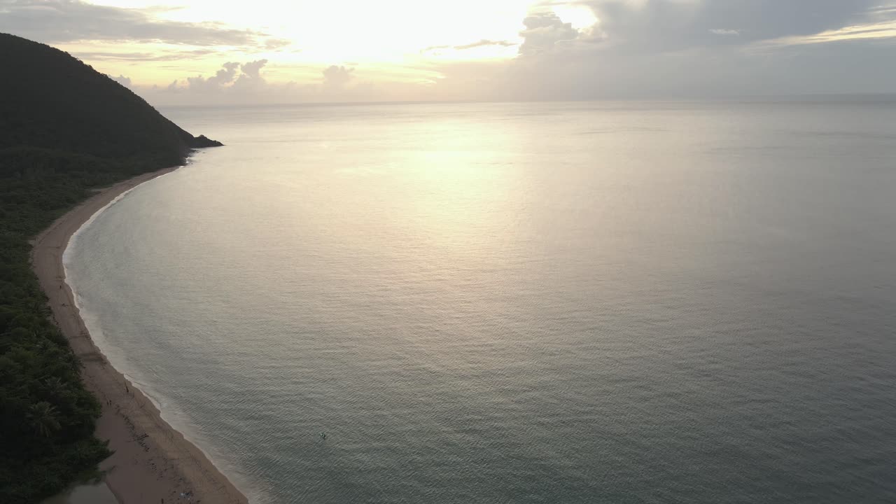 Tropical landscape towards the sea and the sunset on the horizon. Aerial shot. Grande Anse beach, Guadeloupe