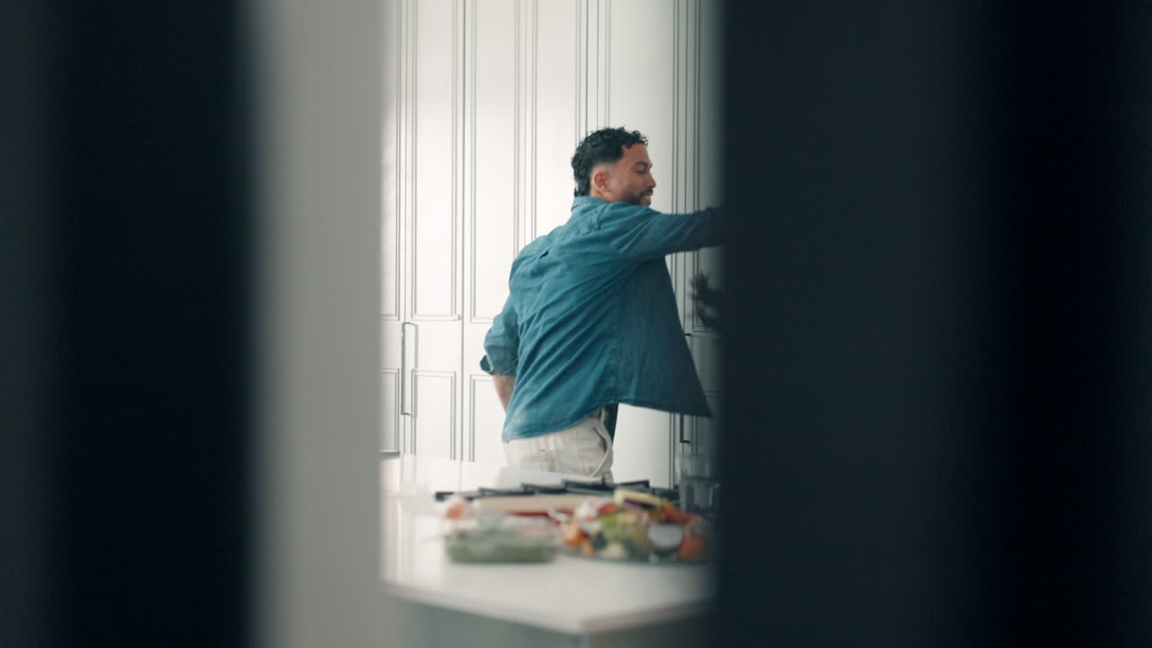 Two people high five each other in a kitchen