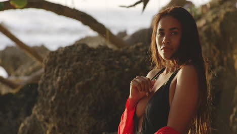 beach sunrise light shines on latin girl models face with seductive smile, copy space