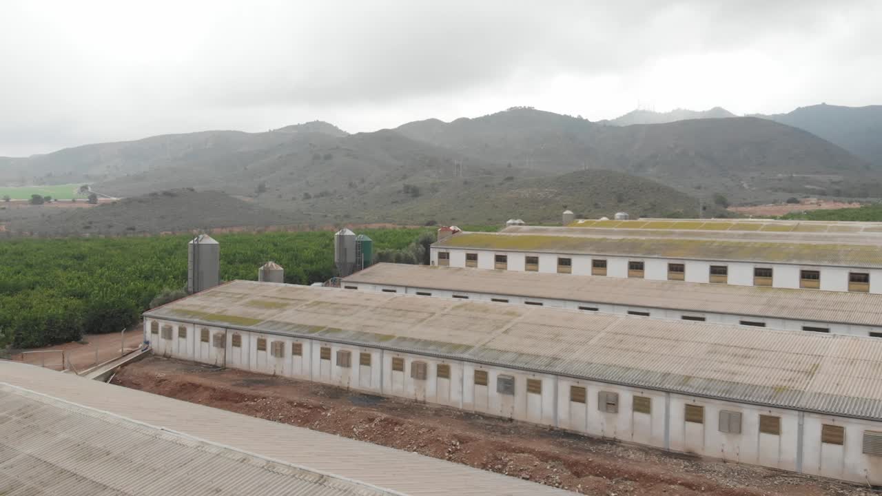 Drone view of industrial factory sheds and agriculture farms