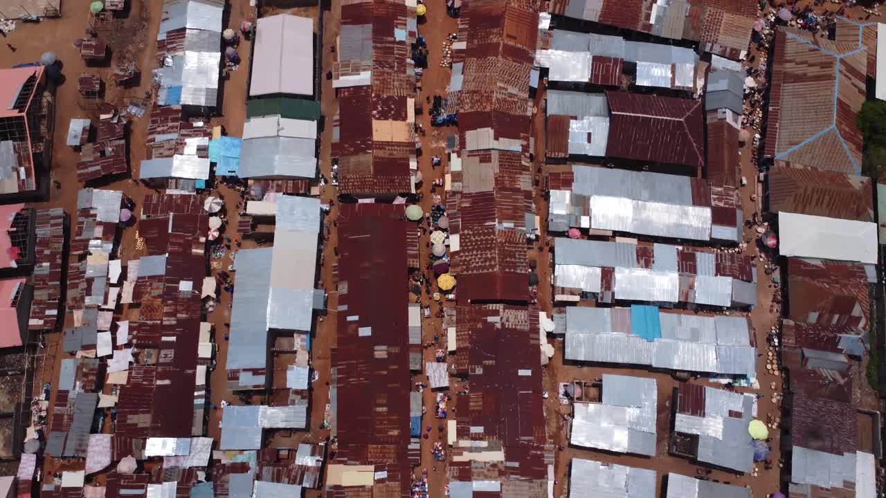 Aerial smooth top down view showing dense rooftops of Karshi vibrant market zone