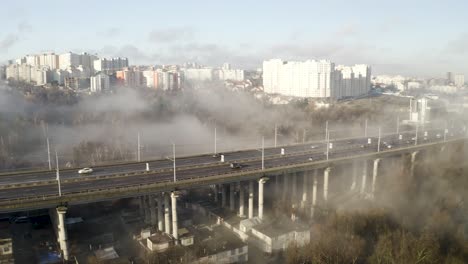 Thick-Fog-over-main-road,-drone-shot-of-smog-and-pollution-hanging-over-Chisinau,-Moldova