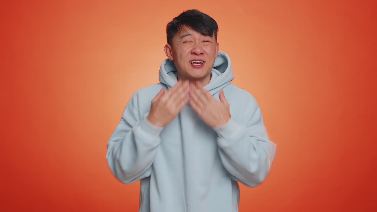 Asian handsome man praying looking upward making wish begging apology asking help forgive me