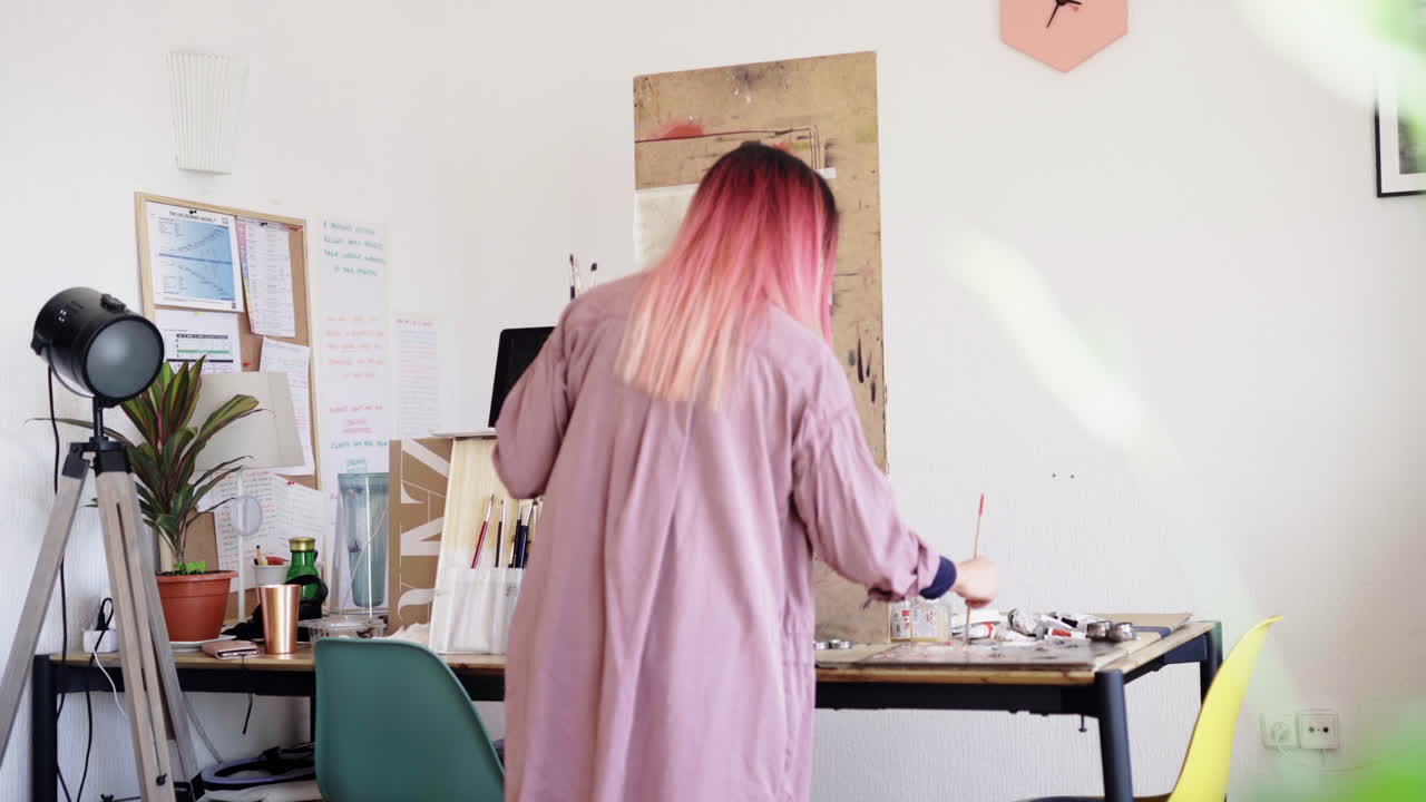 Perfecting portrait painting with more color on canvas at studio