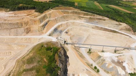 aerial view over large quarry for limestone mining - drone shot