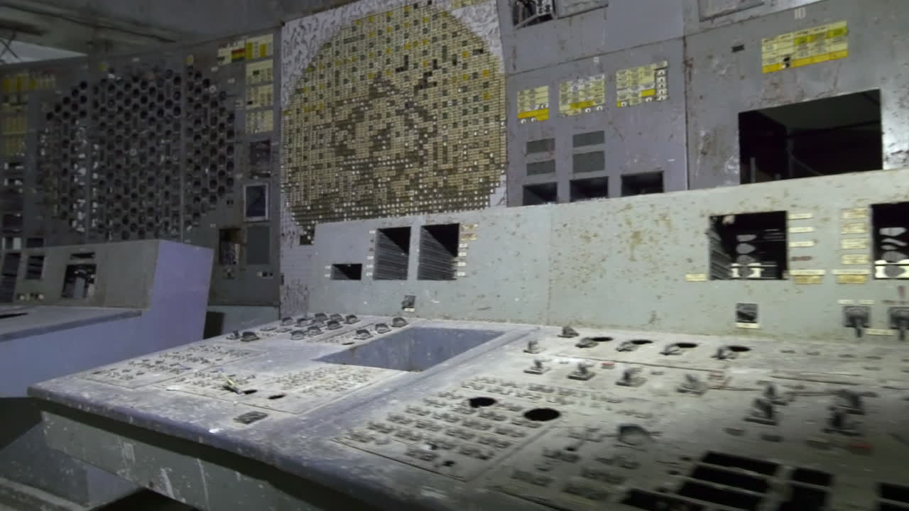 Broken And Dusty Chernobyl Unit 4 Reactor Control Room After The 1986 Disaster In Ukraine. Tracking Shot