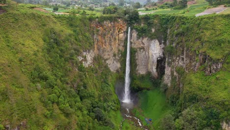 cinematic aerial view of the beautiful and tall sipiso piso waterfall in north sumatra, indonesia