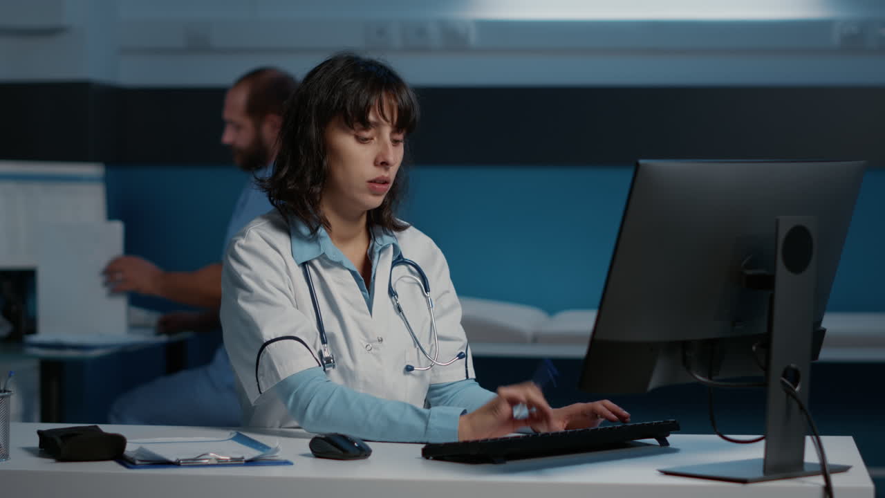 Female Doctor Working Late at Desk