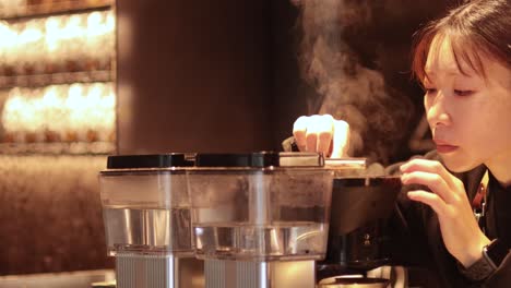 woman preparing coffee at an espresso machine