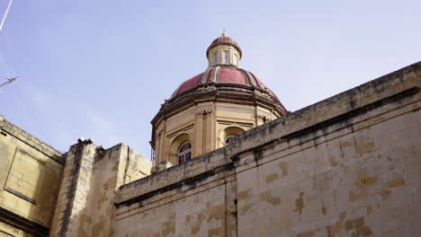 Low-angle-gimbal-shot-of-church-dome-against-clear-sky