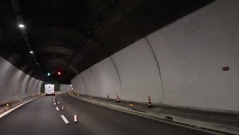 vehicle navigating tunnel with traffic signals