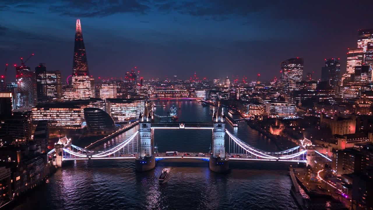 Tower Bridge glows in the night as the capital skyline sparkles beyond