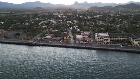 Aerial-Drone-Panoramic-Fly-Loreto-Baja-California-Mexico-Village-Town-Sea-Coast-Seaside-destination,-Mexican-Summer,-mountain-range-background