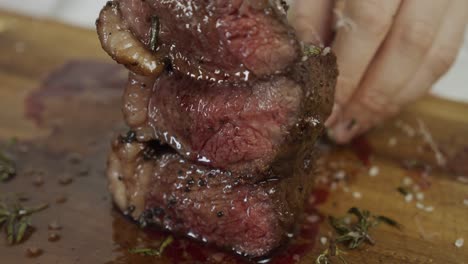 adding salt on top of fried steak