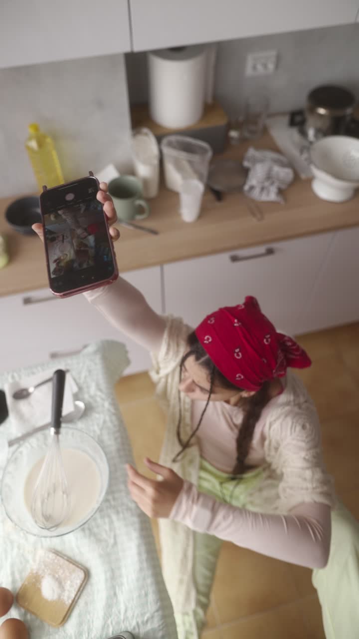 Woman Cooking and Having a Video Call