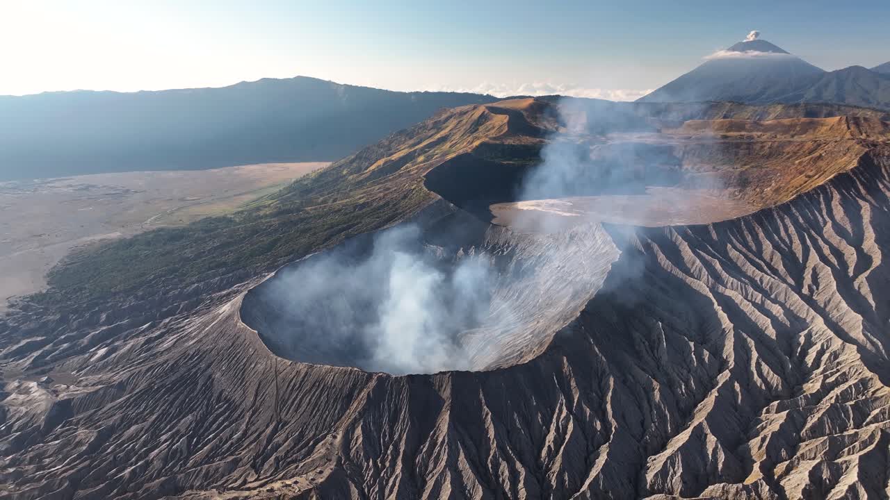 Spectacular aerial view of Bromo volcano craters and cone shaped Semeru on horizon. East Java