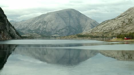 Mountain-in-Norway-with-a-lake-in-the-front-in-which-the-mountain-is-reflected