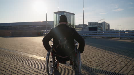 man in wheelchair at a transit hub