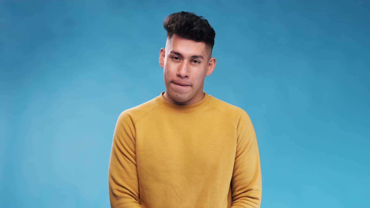 Young man smiling at the camera while standing over an isolated background.