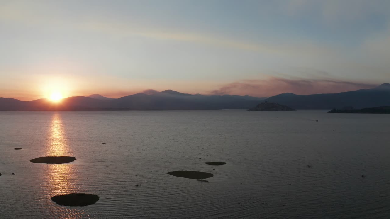 Stunning Sunset over Lake with Island and Mountains