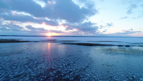 super cold frozen lake in evening sunset blue light