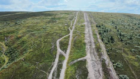 white trail through the green landscape of dalarna, sweden -aerial