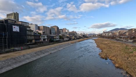 clouds moving over urban river landscape