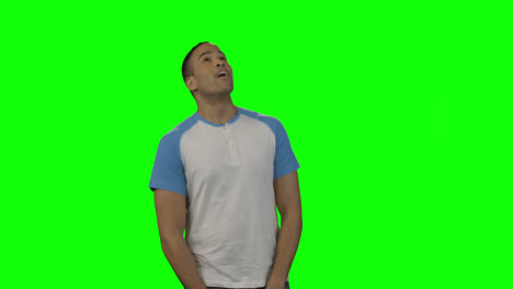 Man-looking-around-against-green-screen