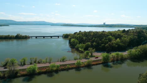 Traffic-On-The-Road-With-View-Of-Bridge-And-Arkansas-Nuclear-One-On-Lake-Dardanelle-In-Arkansas,-USA