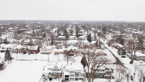 aerial, neighborhood suburb houses covered in snow during winter