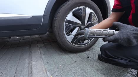 sequential process of a person changing a car tire