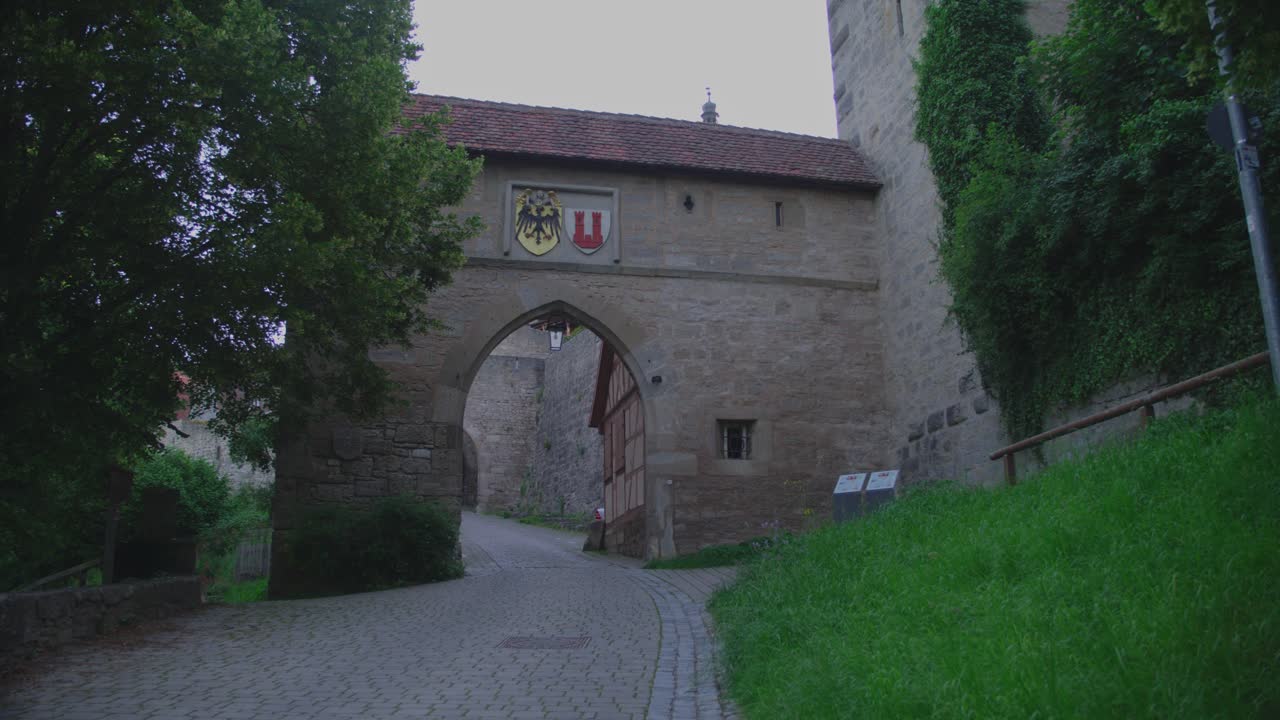 Old town gate in Rothenburg ob der Tauber, Germany, archway with coats of arms