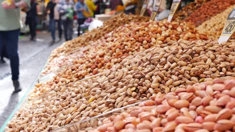 close up of a street market with various nuts, pistachios, almonds, cashews and other dried fruits