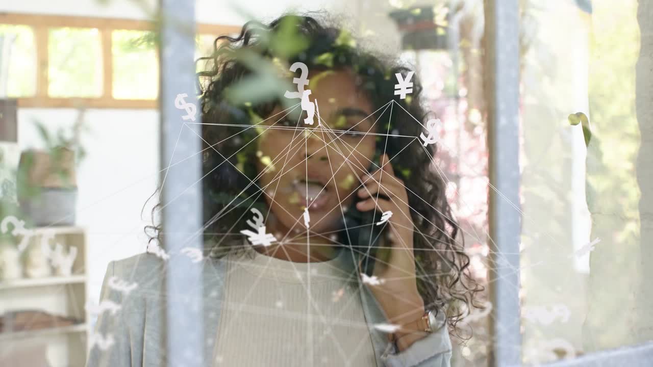 Woman answering call, holding phone, discussing money while animated money icons appearing on glass