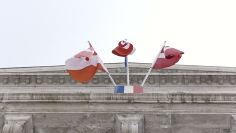 flags of france and estonia on a building