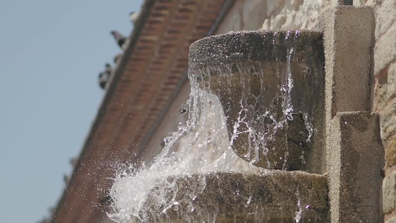 Close-up of a Stone Fountain with Flowing Water and Splashes