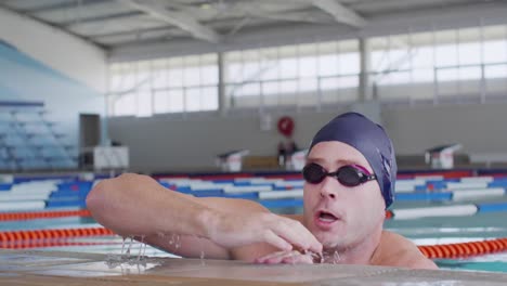 Swimmer-coming-out-of-water-and-looking-at-camera