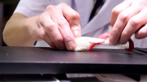chef making traditional japanese sushi
