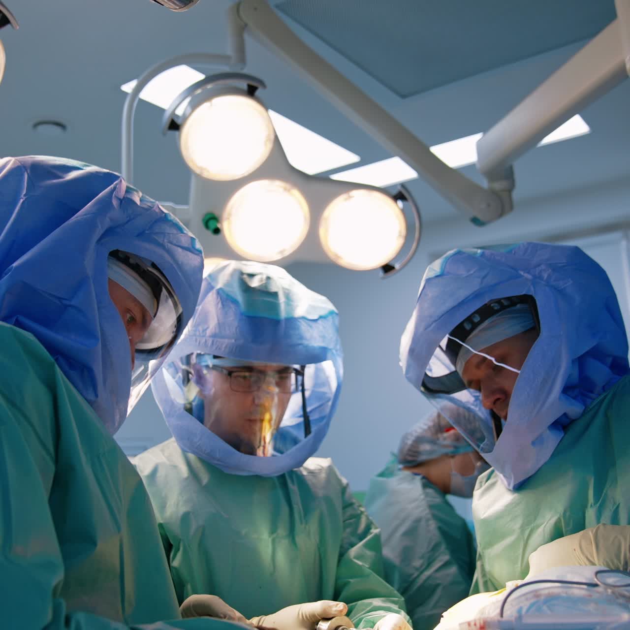 Trauma surgery performed by the professional orthopedics. Doctors wear protective helmets at work