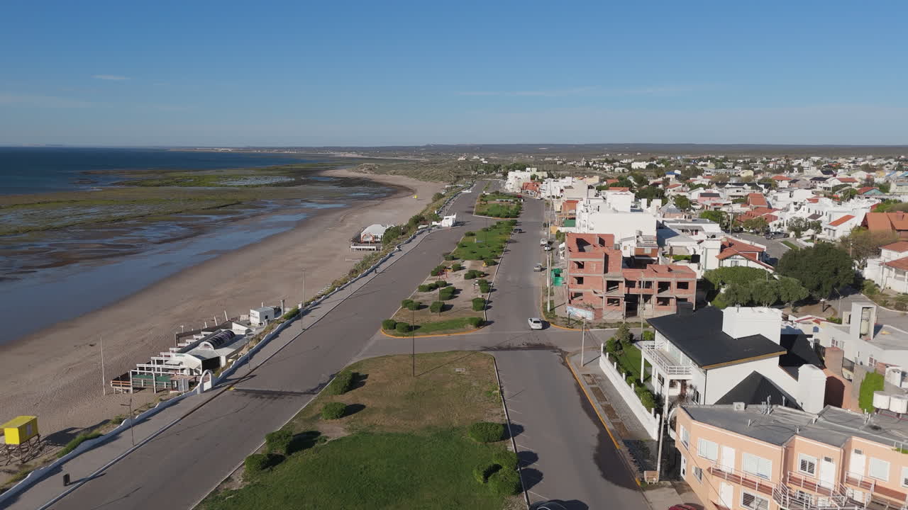 Aerial shot of Las Grutas City, Rio Negro, Patagonia Argentina. The beach, the coastal avenue with its boulevard and the small buildings on a sunny day.