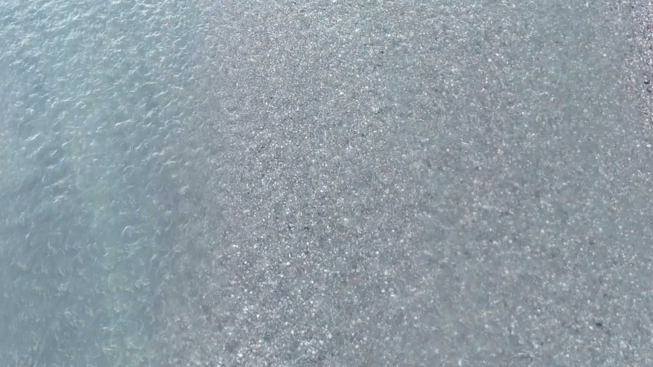 Aerial footage captures the serene, flowing patterns of a river in Glenorchy, New Zealand, with soft lighting and tranquil hues