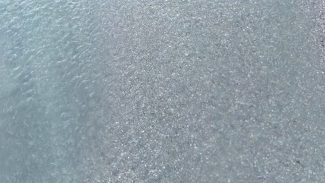aerial footage captures the serene, flowing patterns of a river in glenorchy, new zealand, with soft lighting and tranquil hues