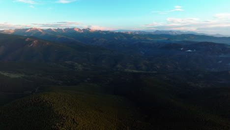 Cinematic-aerial-drone-sunrise-morning-Denver-front-range-foothills-Rocky-Mountains-layers-of-i70-Idaho-Springs-Evergreen-Mount-Evans-14er-wilderness-Squaw-pass-Echo-Mountain-circling-left-motion