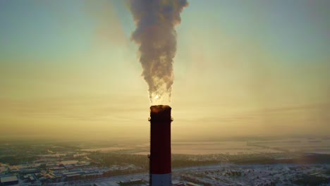 smokestack emissions over a winter cityscape