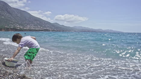 three years old child enjoys the sea at kalamata beach greece slow motion