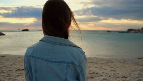 woman sitting on beach 4k