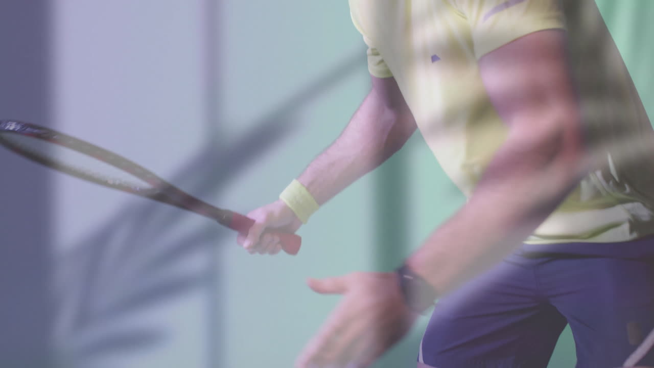 Man gripping squash racquet inside court showing wristband smartwatch overlays for sports analytics