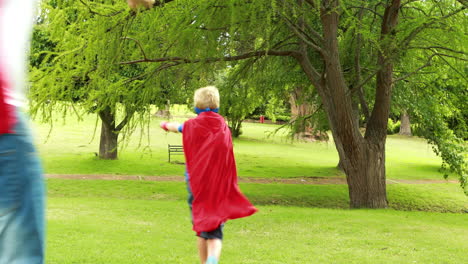 father and son pretending to be superhero